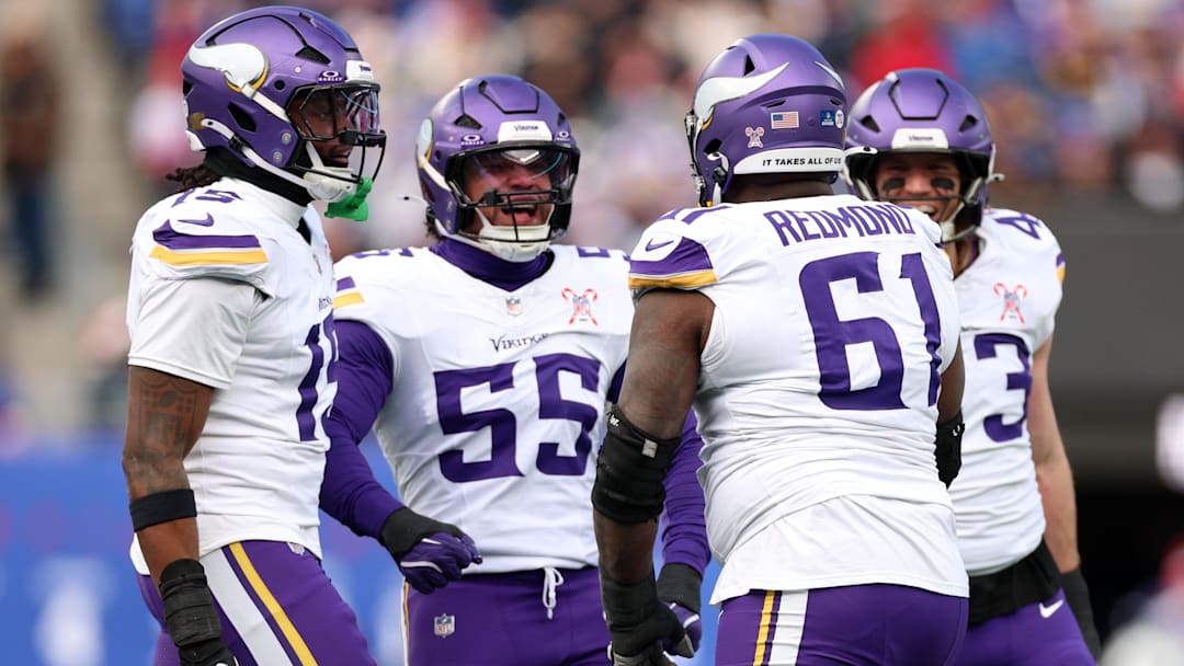 Dec 21, 2025; East Rutherford, New Jersey, USA; Minnesota Vikings defensive lineman Jalen Redmond (61) reacts with linebacker Eric Wilson (55)  during the first half at MetLife Stadium.