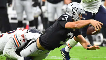 Oct 10, 2021; Paradise, Nevada, USA; Las Vegas Raiders quarterback Nathan Peterman (3) lunges for extra yardage while being tackled by Chicago Bears outside linebacker Khalil Mack (52) during a game at Allegiant Stadium. Mandatory Credit: Stephen R. Sylvanie-USA TODAY Sports
