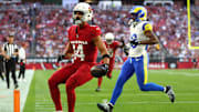 Dec 7, 2025; Glendale, Arizona, USA; Arizona Cardinals wide receiver Michael Wilson (14) runs for a touchdown after a catch against Los Angeles Rams safety Kamren Kinchens (26) during the first half at State Farm Stadium. Mandatory Credit: Mark J. Rebilas-Imagn Images