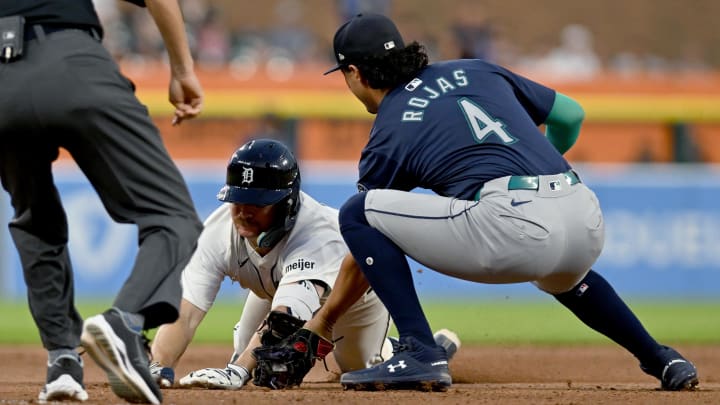 Aug 13, 2024; Detroit, Michigan, USA;  Detroit Tigers catcher Jake Rogers (34) is tagged out at third base trying to stretch a double into a triple by Seattle Mariners third baseman Josh Rojas (4) in the sixth inning at Comerica Park.