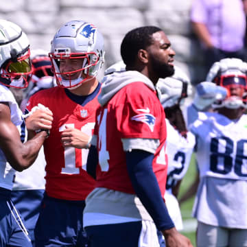 Jul 26, 2024; Foxborough, MA, USA; New England Patriots quarterback Drake Maye (10) reacts at end of a drill with wide receiver Tyquan Thornton (11) during training camp at Gillette Stadium. Mandatory Credit: Eric Canha-USA TODAY Sports