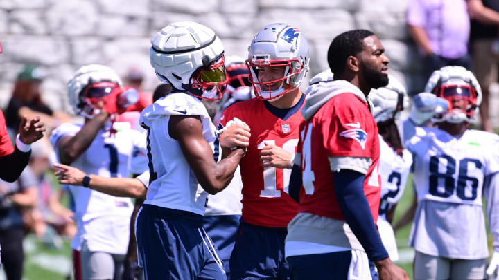 Jul 26, 2024; Foxborough, MA, USA; New England Patriots quarterback Drake Maye (10) reacts at end of a drill with wide receiver Tyquan Thornton (11) during training camp at Gillette Stadium. Mandatory Credit: Eric Canha-USA TODAY Sports