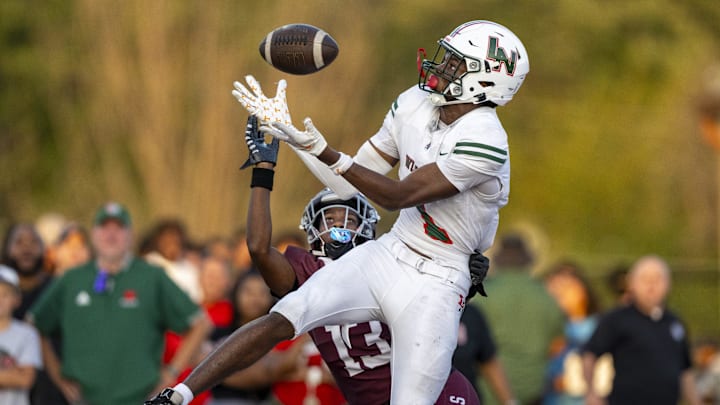 Lawrence North High School sophomore Monshun Sales (1) makes a catch in the end zone to score while being defended by Lawrence Central High School junior DJ Summers (13) during the first half of an IHSAA varsity football game, Friday, Aug. 23, 2024, at Lawrence Central High School.