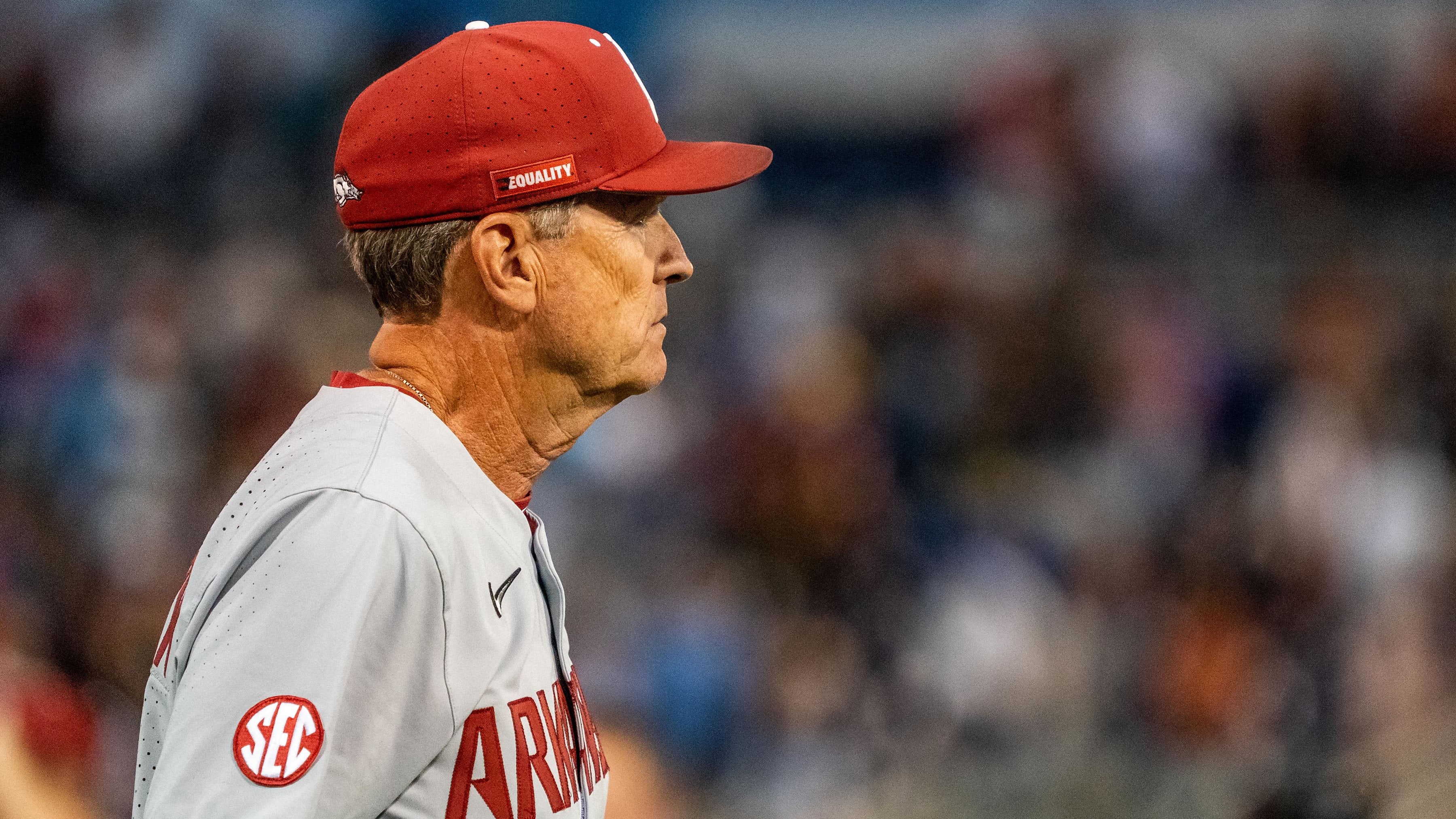 Arkansas coach Dave Van Horn looks on from just beyond the dugout.