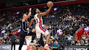 Jan 1, 2025; Detroit, Michigan, USA; Detroit Pistons guard Jaden Ivey (23) drives past Orlando Magic guard Jalen Suggs (4) in the third quarter at Little Caesars Arena. Mandatory Credit: Lon Horwedel-Imagn Images