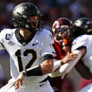 Oct 14, 2023; Blacksburg, Virginia, USA; Wake Forest Demon Deacons quarterback Mitch Griffis (12) throws a pass during the first quarter against the Virginia Tech Hokies at Lane Stadium. Mandatory Credit: Peter Casey-USA TODAY Sports