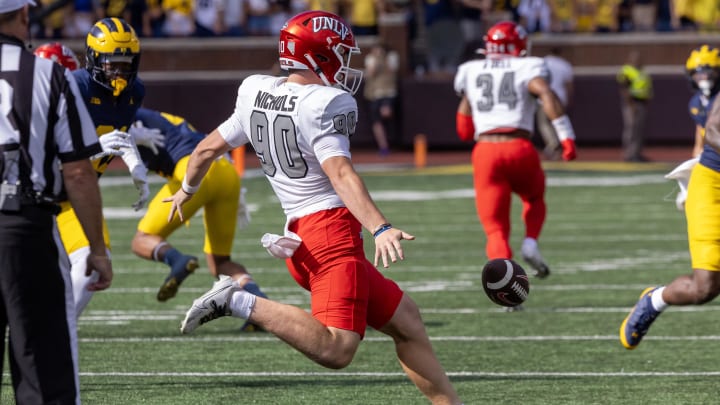 Sep 9, 2023; Ann Arbor, Michigan, USA; UNLV Rebels punter Marshall Nichols (90) kicks the ball against the Michigan Wolverines during the first half at Michigan Stadium. Mandatory Credit: David Reginek-USA TODAY Sports