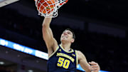 Michigan Wolverines center Vladislav Goldin (50) dunks the ball 
