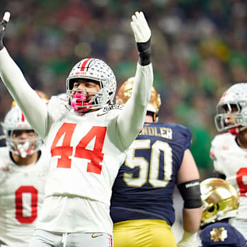 Ohio State Buckeyes defensive end JT Tuimoloau (44) celebrates a tackle of Notre Dame Fighting Irish running back Jeremiyah Love (4) in the first quarter during the College Football Playoff National Championship at Mercedes-Benz Stadium in Atlanta on January 20, 2025.