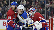 Oct 26, 2024; Montreal, Quebec, CAN; Montreal Canadiens defenseman David Savard (58) moves St.Louis Blues forward Jake Neighbours (63) away from screening  Montreal goalie Sam Montembeault (35) during the second period at the Bell Centre. Mandatory Credit: Eric Bolte-Imagn Images