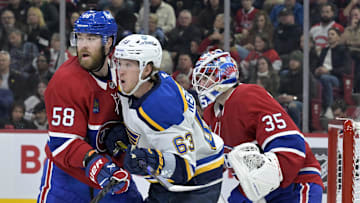 Oct 26, 2024; Montreal, Quebec, CAN; Montreal Canadiens defenseman David Savard (58) moves St.Louis Blues forward Jake Neighbours (63) away from screening  Montreal goalie Sam Montembeault (35) during the second period at the Bell Centre. Mandatory Credit: Eric Bolte-Imagn Images