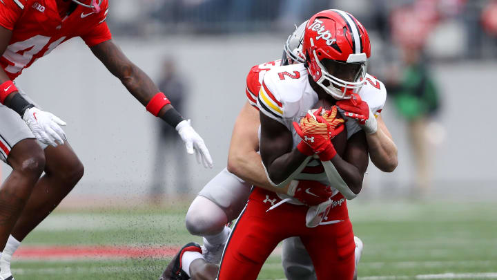 Oct 7, 2023; Columbus, Ohio, USA;  Maryland Terrapins defensive back Beau Brade (2) makes the catch as Ohio State Buckeyes linebacker Tommy Eichenberg (35) makes the tackle during the second quarter at Ohio Stadium. Mandatory Credit: Joseph Maiorana-USA TODAY Sports