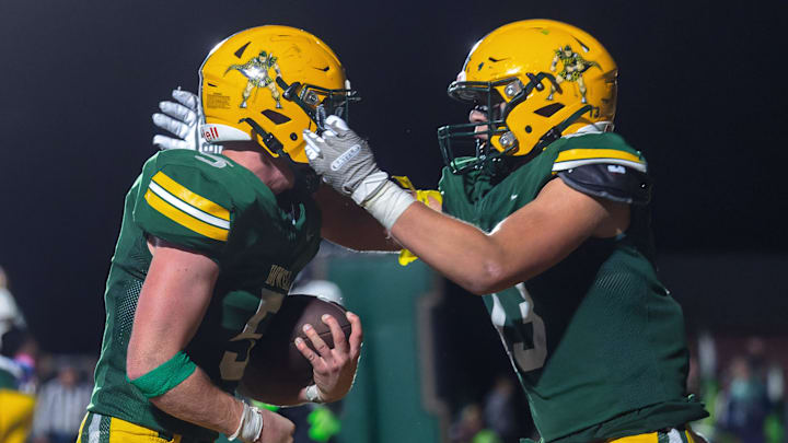 Howells Justin Jones (left) and Jackson Pahl celebrate a touchdown during a victory over Belleville Friday, Oct. 25, 2024.