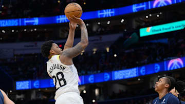 Mar 5, 2025; Washington, District of Columbia, USA; Utah Jazz forward Brice Sensabaugh (28) takes a jump shot over Washington Wizards guard Bub Carrington (8) during the fourth quarter at Capital One Arena. Mandatory Credit: Reggie Hildred-Imagn Images