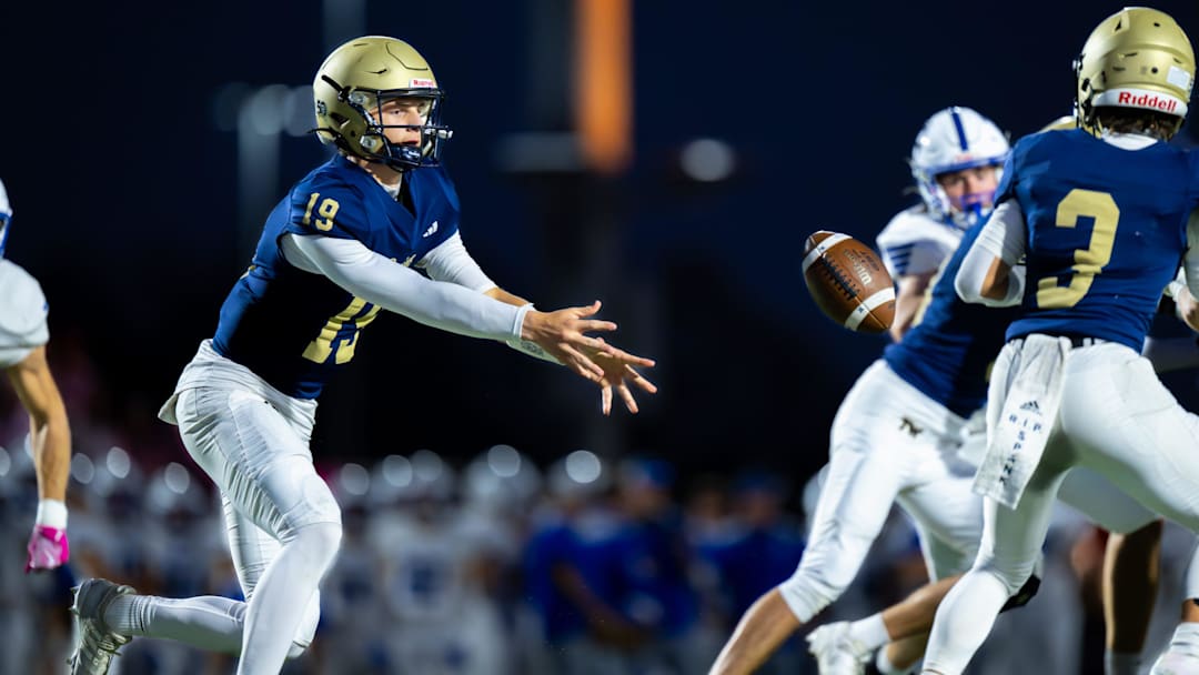 Tri-West Hendricks High School junior Jack Sorgi (19) pitches the ball to junior Braxton Fleece (3) during the first half of an IHSAA varsity football game against Bishop Chatard High School, Friday, Oct. 10, 2025, at Tri-West Hendricks High School.