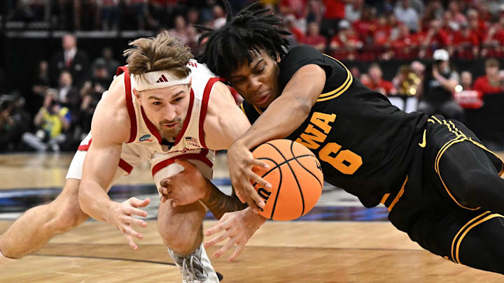 Mar 26, 2026; Houston, TX, USA; Nebraska Cornhuskers guard Sam Hoiberg (1) and Iowa Hawkeyes guard Tavion Banks (6) dive for a loose ball in the first half during a Sweet Sixteen game of the South Regional of the men's 2026 NCAA Tournament at Toyota Center. Mandatory Credit: Maria Lysaker-Imagn Images