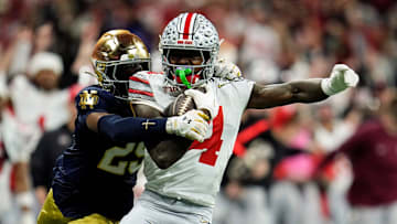 Ohio State Buckeyes wide receiver Jeremiah Smith (4) makes a catch against Notre Dame Fighting Irish cornerback Christian Gray (29) in the fourth quarter during the College Football Playoff National Championship at Mercedes-Benz Stadium in Atlanta on January 20, 2025.