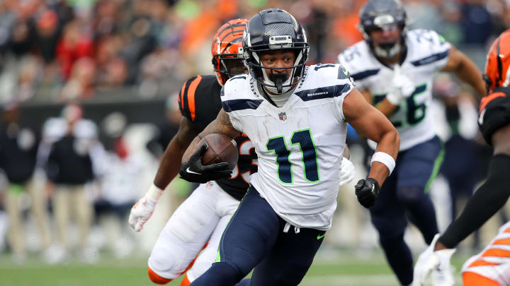 Oct 15, 2023; Cincinnati, Ohio, USA;  Seattle Seahawks wide receiver Jaxon Smith-Njigba (11) runs after the catch as Cincinnati Bengals safety Nick Scott (33) defends during the fourth quarter at Paycor Stadium.