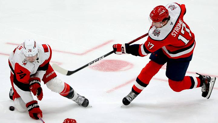 Jan 31, 2026; Washington, District of Columbia, USA; Washington Capitals center Dylan Strome (17) takes a shot past Carolina Hurricanes defenseman Jaccob Slavin (74) during the third period at Capital One Arena. Mandatory Credit: Daniel Kucin Jr.-Imagn Images