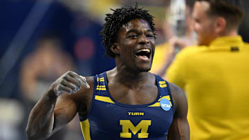 Apr 19, 2025; Ann Arbor, MI, USA;  Michigan gymnast Fred Richard reacts after finishing his parallel bars routine during the NCAA Men’s Gymnastics National Championship Finals at Crisler Center. Mandatory Credit: Lon Horwedel-Imagn Images