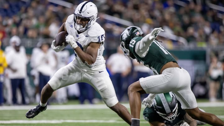 Penn State running back Nicholas Singleton runs with the ball against the Michigan State Spartans. 