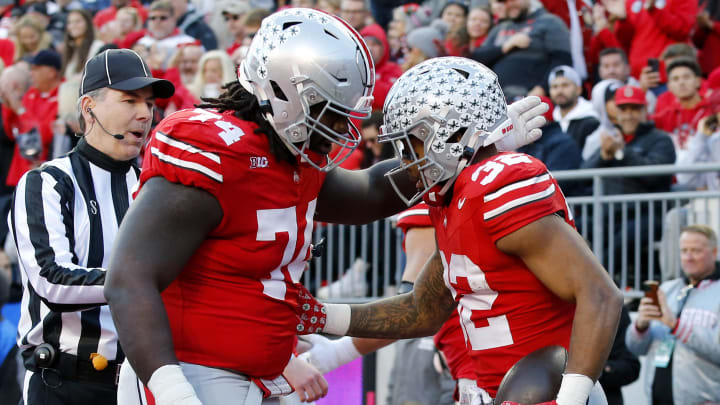 Nov 18, 2023; Columbus, Ohio, USA;  Ohio State Buckeyes running back TreVeyon Henderson (32) celebrates his touchdown run with offensive lineman Donovan Jackson (74) during the first quarter against the Minnesota Golden Gophers at Ohio Stadium. Mandatory Credit: Joseph Maiorana-USA TODAY Sports