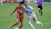 Sep 28, 2023; Austin, Texas, USA; West Virginia Mountaineers forward Jordyn Wilson (11) and Texas Longhorns defender Lauren Lapomarda (25) battle for the ball during the match at Mike A. Myers Stadium and Soccer Field in Austin, Texas. Mandatory Credit: Scott Wachter-USA TODAY Sports