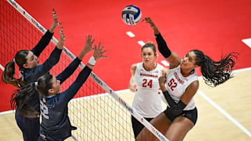 Wisconsin middle blocker Carter Booth (52) hits against Marquette in a spring match Wednesday, April 16, 2025, at the UW Field House in Madison, Wisconsin.