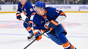 Oct 26, 2024; Elmont, New York, USA;  New York Islanders center Mathew Barzal (13) skates with the puck against the Florida Panthers during the second period at UBS Arena. Mandatory Credit: Dennis Schneidler-Imagn Images