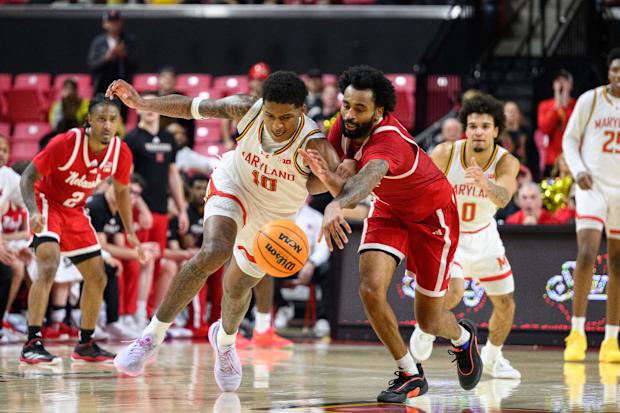 Maryland Terrapins forward Julian Reese (10) and Nebraska Cornhuskers guard Brice Williams (3) fight for a loose ball.