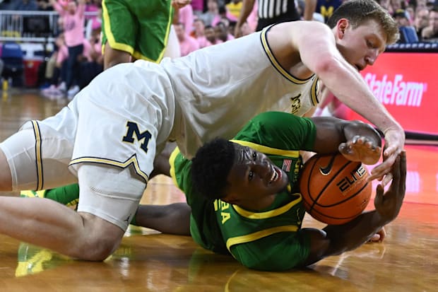 Feb 5, 2025; Ann Arbor, Michigan, USA;  Oregon Ducks guard TJ Bamba (5) calls a timeout while trying to keep the ball away fr