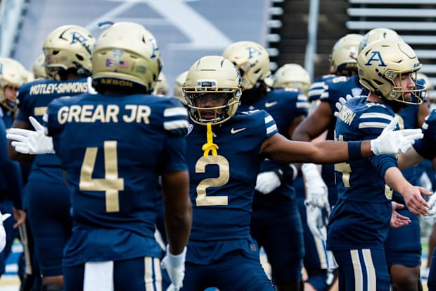Akron Zips wide receiver Marcel Williams (2) gestures to Akron Zips wide receiver Tim Grear, Jr. (4) during warmups
