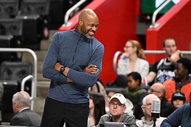 Orlando Magic head coach Jamahl Mosley laughs with his assistant coaches