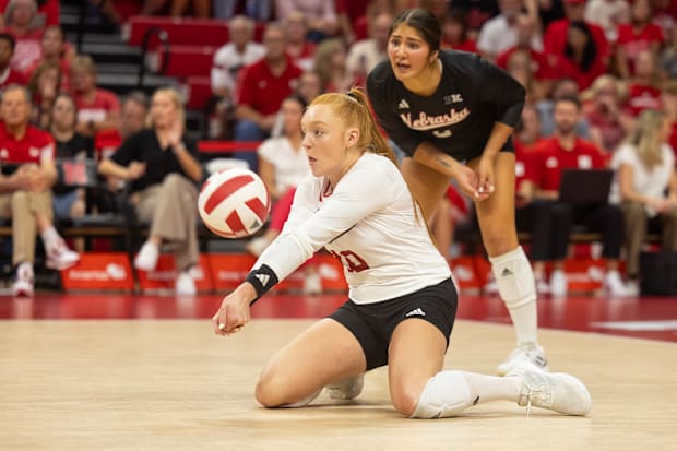 Nebraska defensive specialist Oliva Mauch digs a ball against The Citadel while libero Lexi Rodriguez eyes the ball.