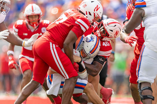 Linebackers Willis McGahee and Dawson Merritt tackle QB Jake Weir during Nebraska's 2025 game against Houston Christian