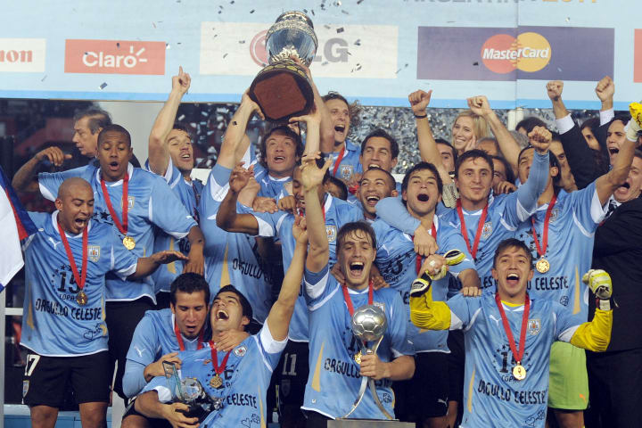 Uruguayan captain Diego Lugano (C) raise