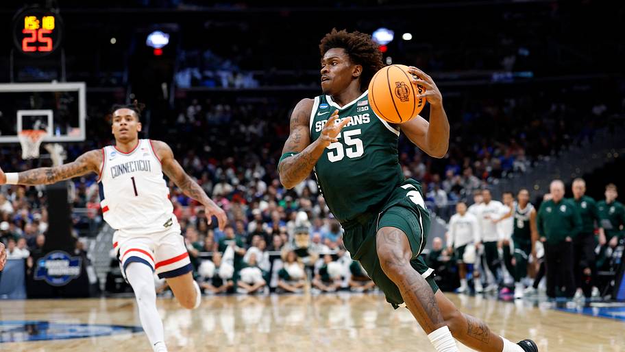 Michigan State forward Coen Carr dribbles the ball.