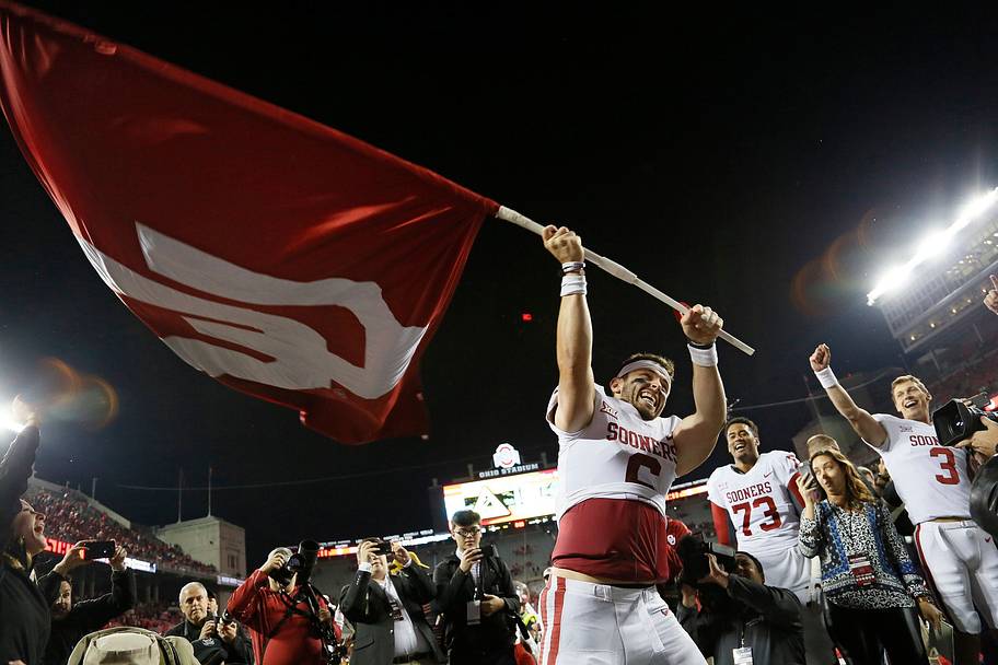 Oklahoma quarterback Baker Mayfield waves the Sooners’ flag following their 31–16 win over Ohio State in 2017.