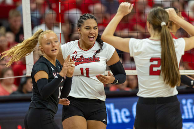 Nebraska DS/Libero Olivia Mauch, outside hitter Teraya Sigler, and setter Bergen Reilly celebrate a point.