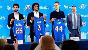 From left, Ajay Mitchell, Dillon Jones and Nikola Topic stand with Thunder general manager Sam Presti during an introductory press conference for the 2024 Thunder draft picks at Oklahoma Contemporary Arts Center in Oklahoma City, Saturday, June, 29, 2024.