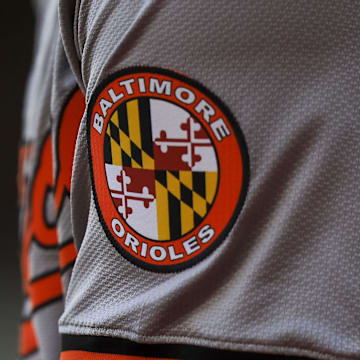 May 5, 2024; Cincinnati, Ohio, USA; The Baltimore Orioles logo on the sleeve of designated hitter Gunnar Henderson (2) as he prepares on deck during the seventh inning against the Cincinnati Reds at Great American Ball Park. Mandatory Credit: Katie Stratman-Imagn Images