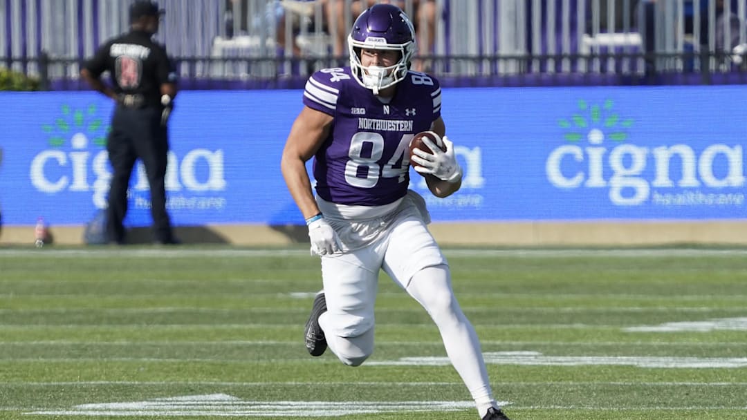 Sep 27, 2025; Evanston, Illinois, USA; Northwestern Wildcats tight end Hunter Welcing (84) catches a pass against the UCLA Bruins during the first half at Northwestern Medicine Field at Martin Stadium. Mandatory Credit: David Banks-Imagn Images