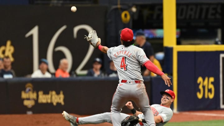 Jul 28, 2024; St. Petersburg, Florida, USA; Cincinnati Reds third baseman Santiago Espinal (4) and  left fielder Spencer Steer (7) attempt to catch a foul ball in the fifth inning against the Tampa Bay Rays at Tropicana Field. Mandatory Credit: Jonathan Dyer-USA TODAY Sports