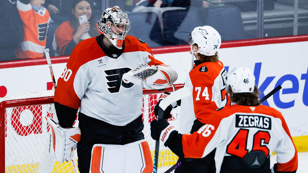 Apr 11, 2026; Winnipeg, Manitoba, CAN;  Philadelphia Flyers goalie Dan Vladar (80)  is congratulated by his teammates on his win against the Winnipeg Jets at the end of the third period at Canada Life Centre. Mandatory Credit: Terrence Lee-Imagn Images