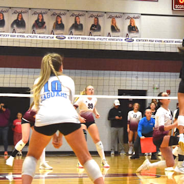 Mercy Academy players Nalani Derringer (8) and Allison O'Shea (32) block the ball Monday, Nov. 3, 2025, in a Kentucky High School Girls State Tournament match against Assumption High School.