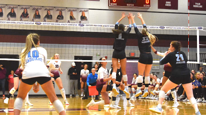 Mercy Academy players Nalani Derringer (8) and Allison O'Shea (32) block the ball Monday, Nov. 3, 2025, in a Kentucky High School Girls State Tournament match against Assumption High School.