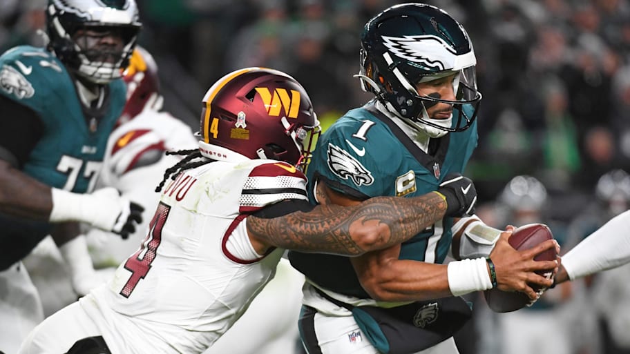 Philadelphia Eagles quarterback Jalen Hurts (1) is sacked by Washington Commanders linebacker Frankie Luvu (4). | Eric Hartline-Imagn Images