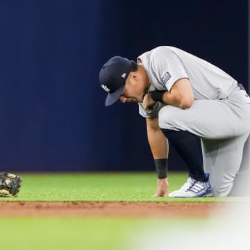  New York Yankees shortstop Anthony Volpe (11) kneels to the field during the first inning against the Toronto Blue Jays at Rogers Centre on June 29.
