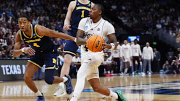Texas A&M Aggies guard Wade Taylor IV (4) dribbles the ball against Michigan Wolverines guard Nimari Burnett (4) during the first half in the second round of the NCAA Tournament  at Ball Arena.