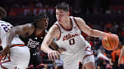 Nov 11, 2025; Champaign, Illinois, USA;  Illinois Fighting Illini forward David Mirkovic (0) drives the ball past Texas Tech Red Raiders guard Jaylen Petty (11)  during the first half at State Farm Center. Mandatory Credit: Ron Johnson-Imagn Images